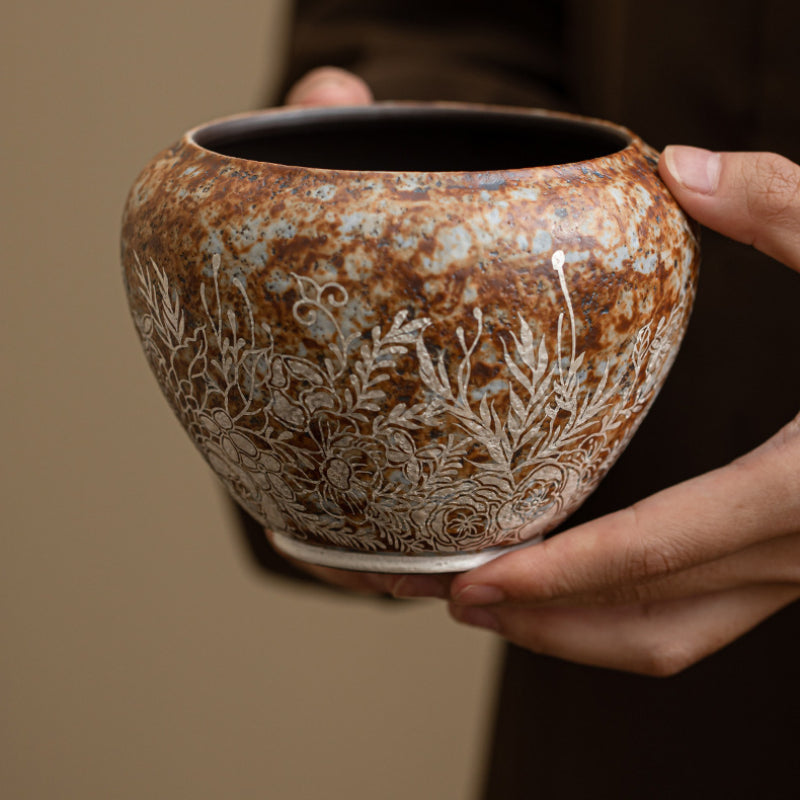 Kiln-Transmutated-Ceramic-Lidless-Jar-with-Silver-Detailing-Floral-in-hand