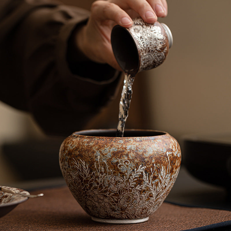 Kiln-Transmutated-Ceramic-Lidless-Jar-with-Silver-Detailing-Floral-pouring-out-water