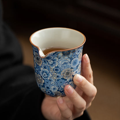 Ru-Crackles-Ceramic-Pitcher-with-Metallic-Detailing-of-Blue-Floral-Patterns-in-hand