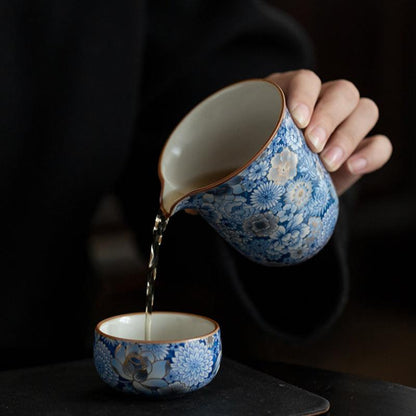 Ru-Crackles-Ceramic-Pitcher-with-Metallic-Detailing-of-Blue-Floral-Patterns-pouring-out-water