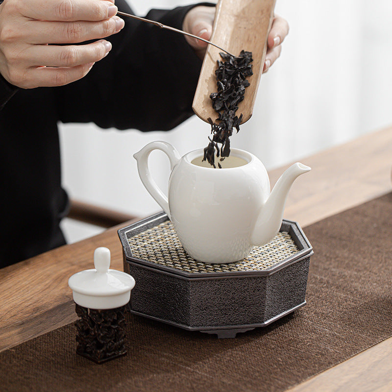 Mutton-Fat Porcelain Slouch Shoulder Teapot with tea leaves pouring into