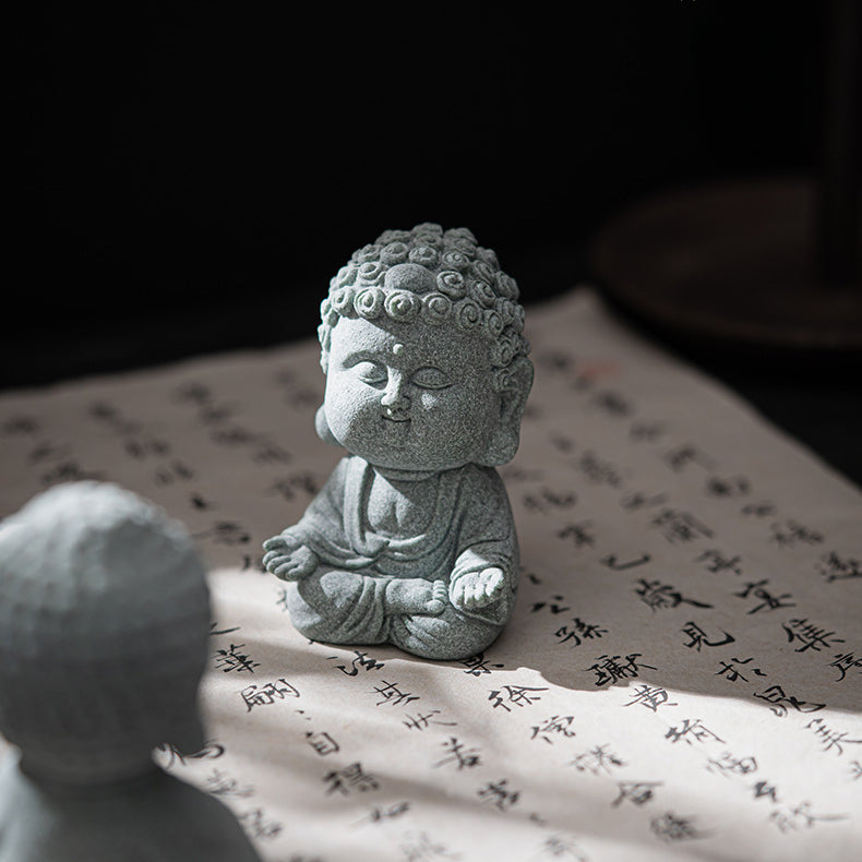 Sandstone Buddha Decor Incense Holder sitting on a Chinese calligraphy manuscript as if the buddha enjoys the sun